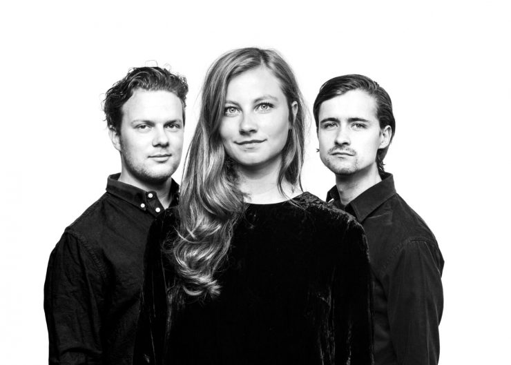 Het Tilburgse podium kijkt uit naar het concert van Mudita: “In de groep worden de muzikale achtergronden van drie verweven in één geluid. Sjoerd van Eijck achter de toetsen, Koen Smits op trompet en zangeres Sanne Rambags zoeken ook de muzikale grenzen.”