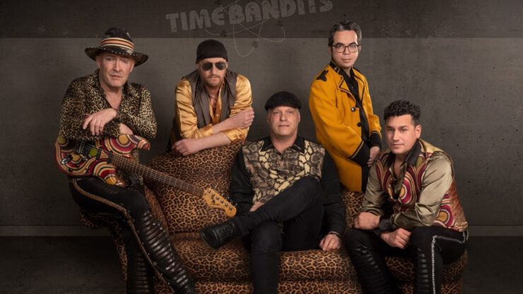 Frontman en zanger-gitarist Alides Hidding dompelt je met Time Bandits (groepsportret huidige bezetting) live ook onder in de sfeer van de jaren 80 bij pop-uppodium Heyhoef-Backstage.